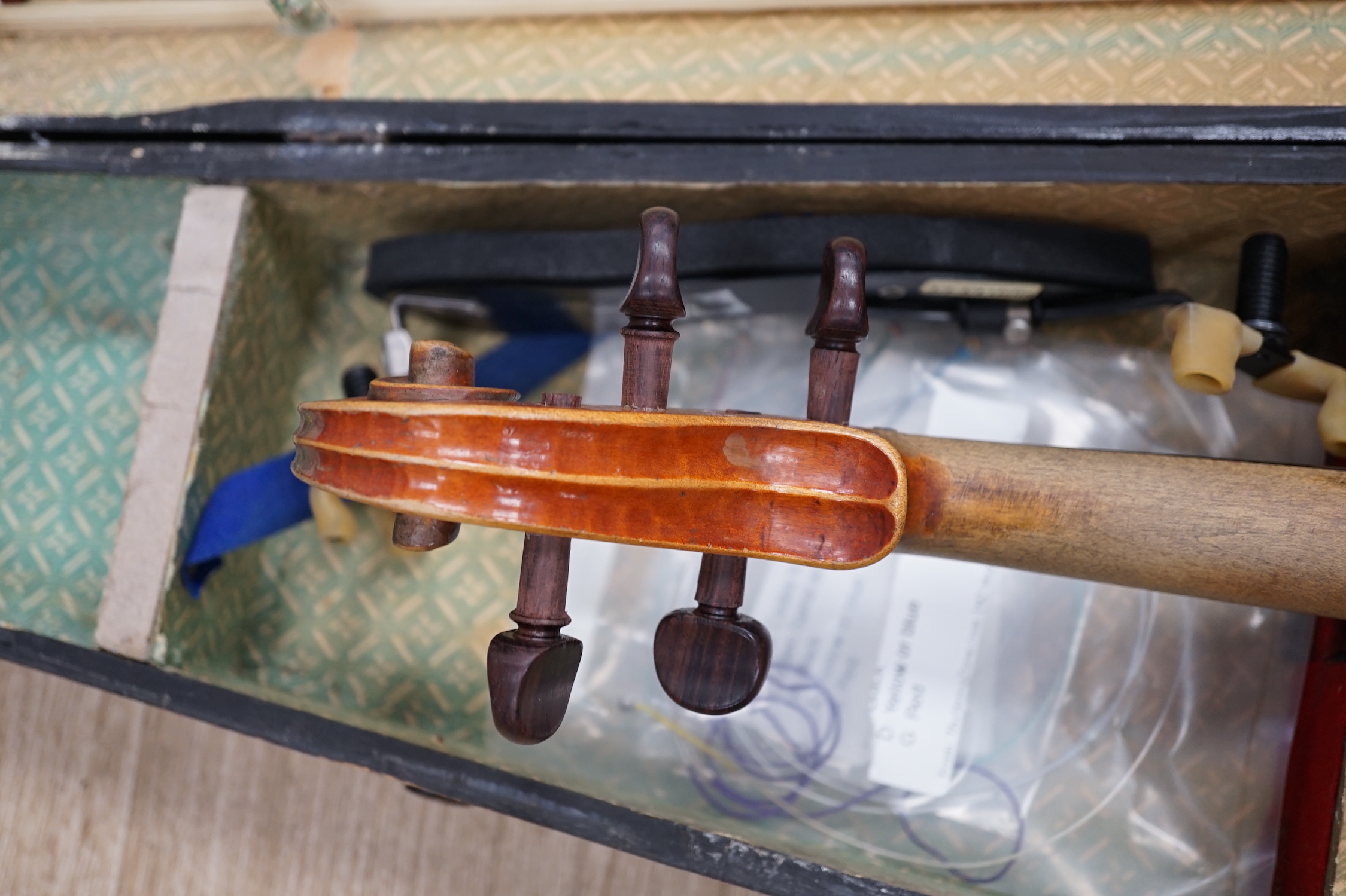 A mid 19th century cased French violin, length of body 35.5cm, with bow, simulated ivory tip